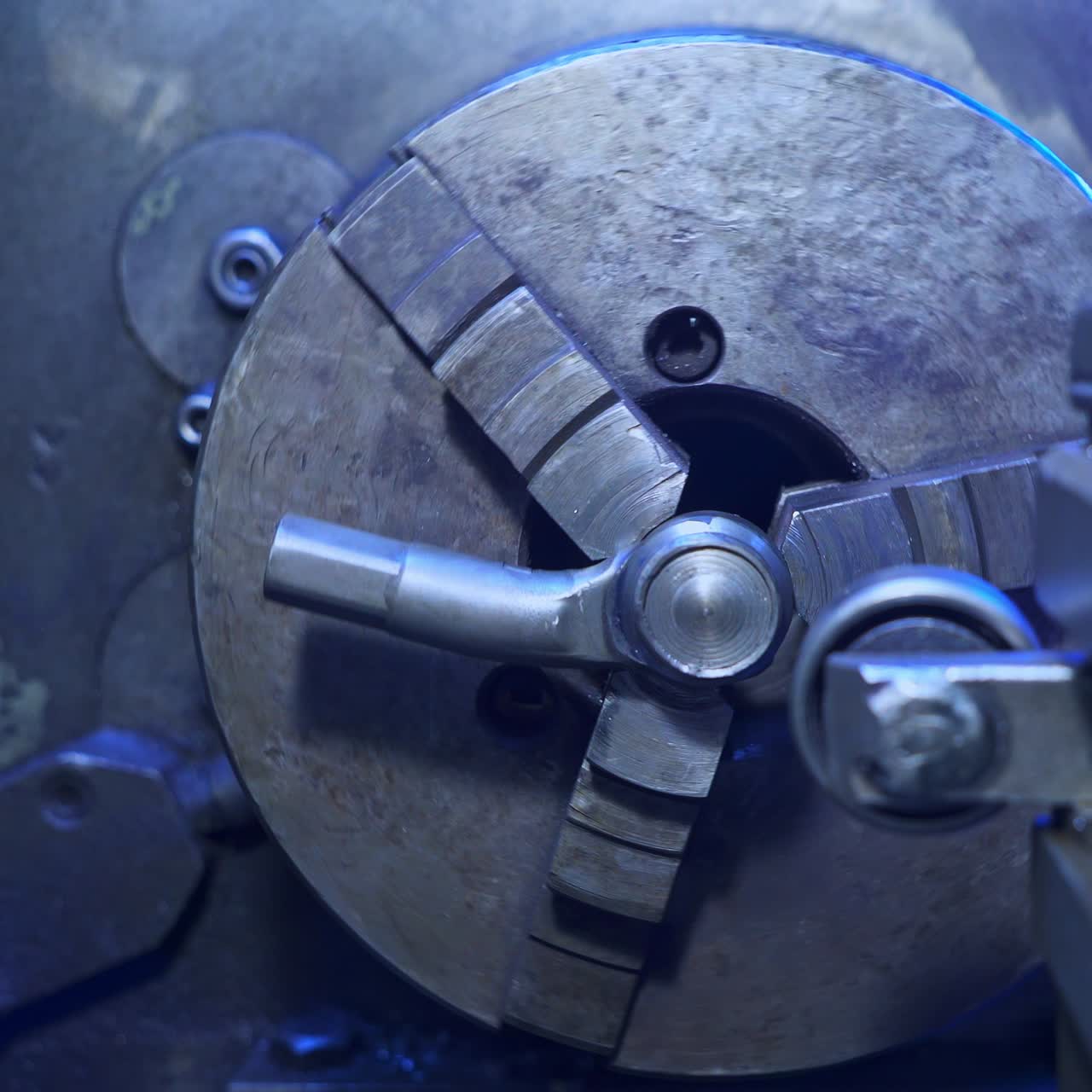 Round rotating detail in turning lathe. Elements on a metal lathe machine. Turner's workshop close up