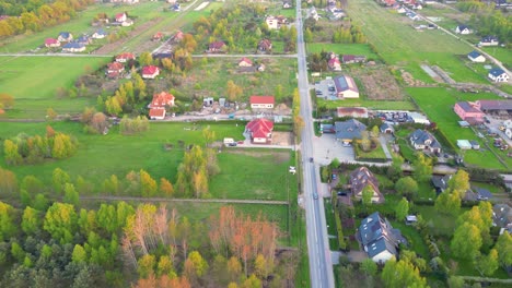 Aerial-straight-flight-over-traffic-on-main-street-of-small-town