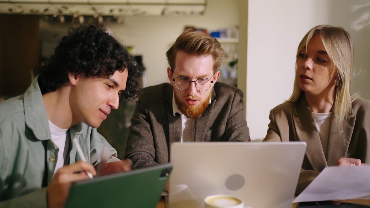 Three colleagues having a business meeting at a cafe