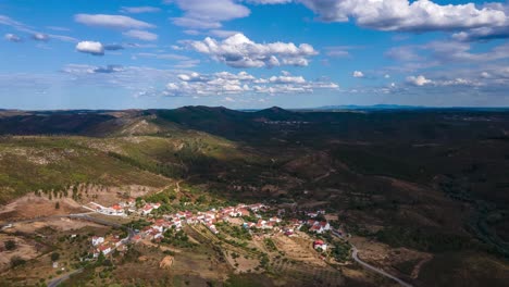 aerial hyperlapse over a small village surrounded by mountains