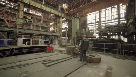 industrial worker performing maintenance on metal structures in a factory