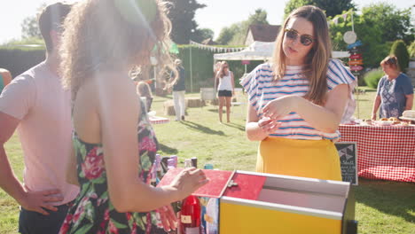 Zeitlupenaufnahme-Eines-Paares,-Das-Am-Tombola-Stand-Beim-Geschäftigen-Sommergartenfest-Den-Preis-Gewinnt