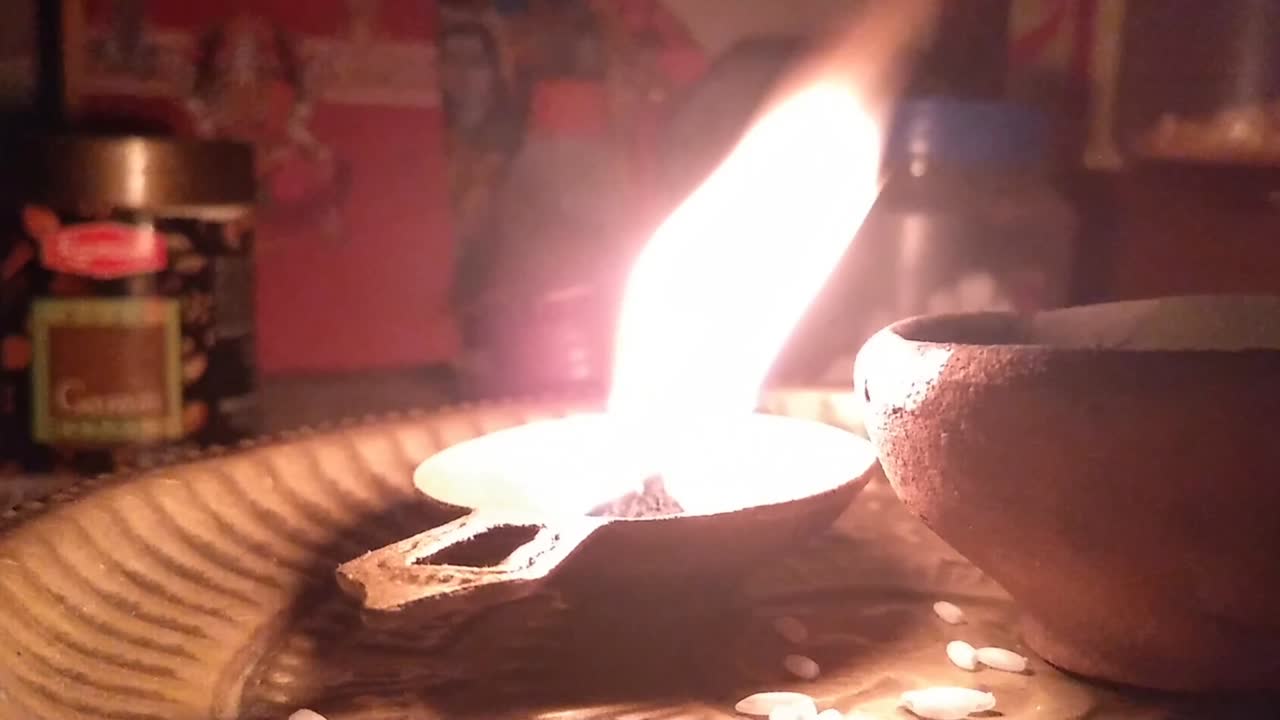 Happy Diwali - Colorful metal diya lamps lit during diwali celebration. clay diya burning in from of God.