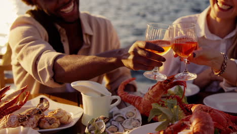 friends enjoying a luxurious seafood dinner by the ocean at sunset