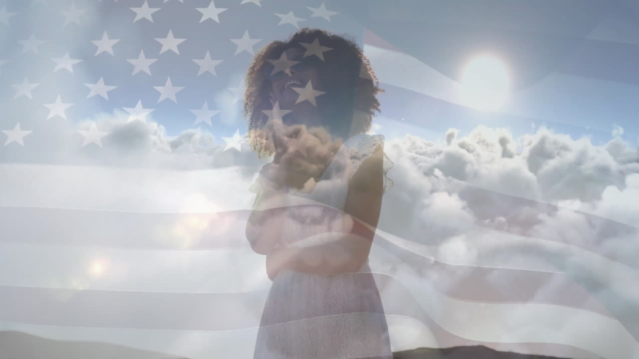 Standing over clouds, woman with American flag animation overlay in background