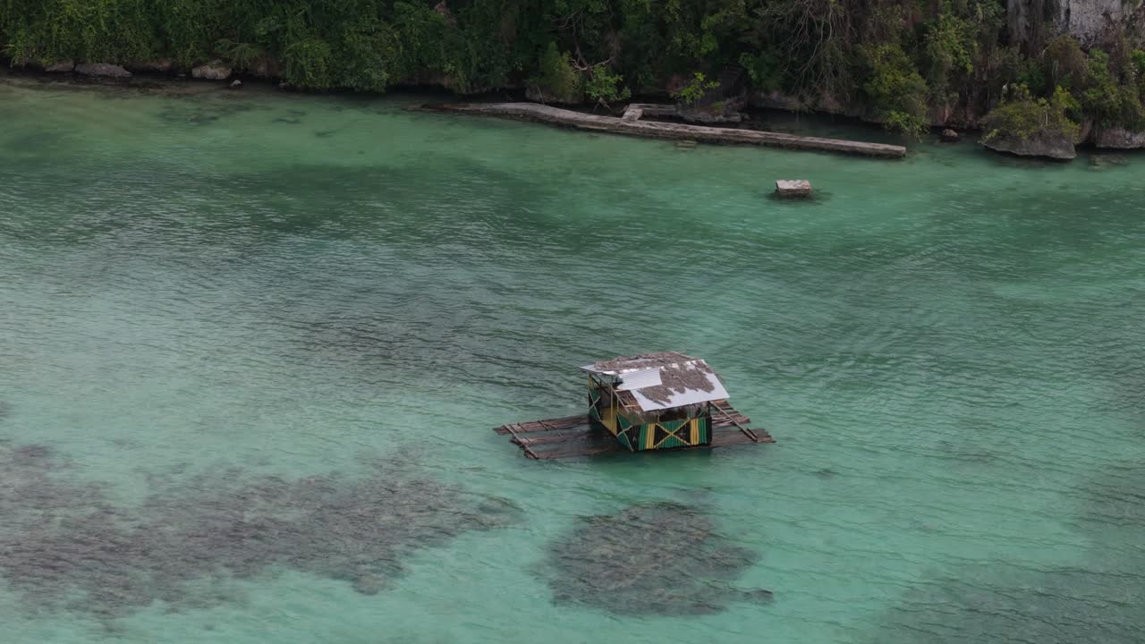Jamaican Flag On A hut Floating On A Bamboo Raft In Jamaica