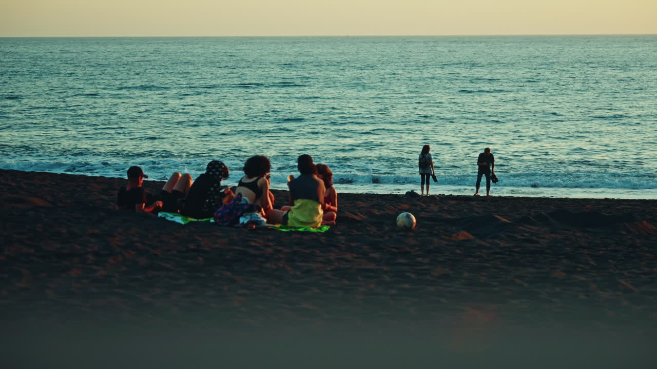 Close up shot of a small group of friends having fun and enjoying their time at the beach in Costa Rica.