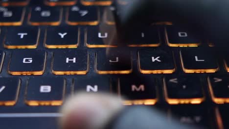 hacker hand stealing data from laptop top down