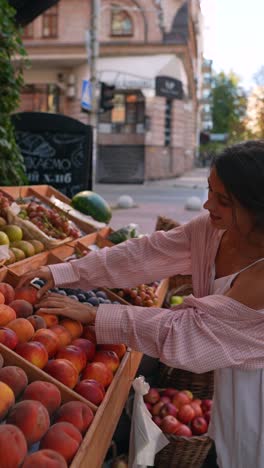 woman buying fruit at a street market