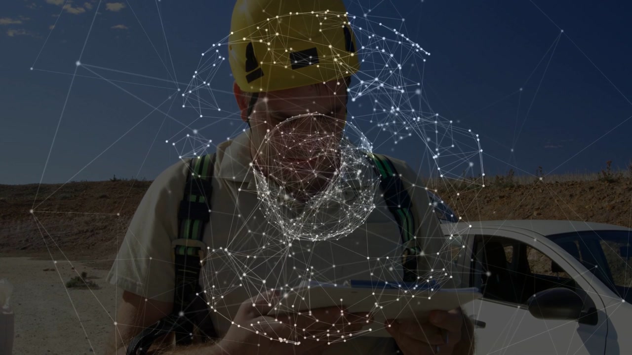 Vertical video: Man in hardhat checking map, using phone at windfarm as net sphere appearing