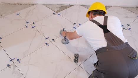 top view of laying ceramic tiles using tools and adhesive mixtures vertical video