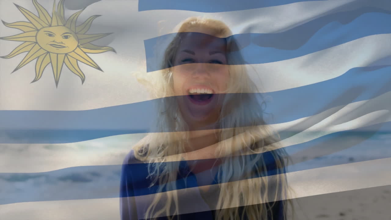 Holding Uruguay flag, smiling woman at beach with animation overlay