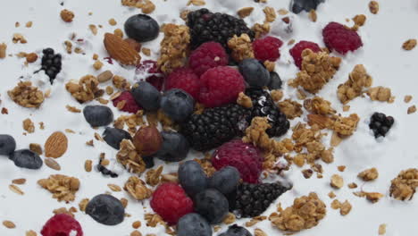 healthy berry crunchy breakfast with natural yogurt in super slow motion closeup