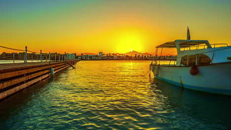 rustic boat docked near wooden jetty in tropical paradise resort during golden sunrise