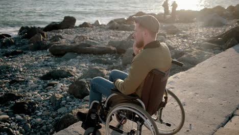 disabled man enjoying the sunset at the beach