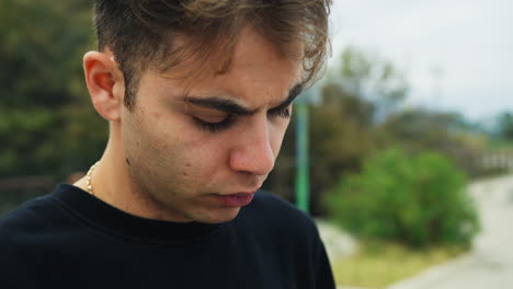 fed up boy looks at the phone waiting for news that never arrives