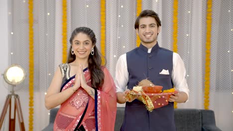 indian couple standing in front of temple