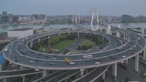 motion time lapse of traffic on nanpu bridge spiral road day to night , shanghai, china in 4k video