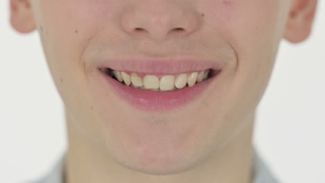 close up of smiling lips of young man