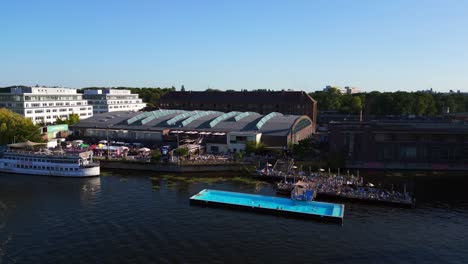 Nice-aerial-top-view-flight-bathing-pool-ship-on-border-river-Spree,-west-Berlin-Germany-evening-summer-23