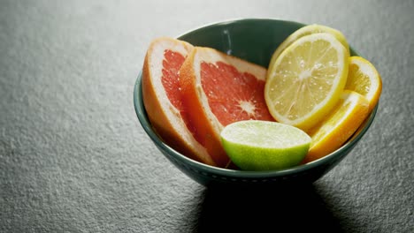 various citrus slices in bowl on grey background 4k 4k