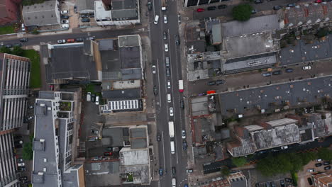 Aerial-birds-eye-overhead-top-down-panning-view-of-long-queue-of-cars-standing-in-traffic-jam-in-city-street.-London,-UK