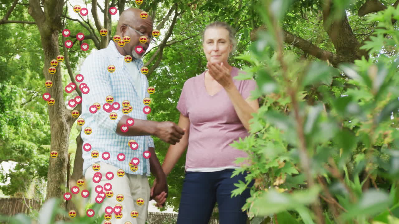 Senior couple walking through lush garden, displaying floating heart icons for health