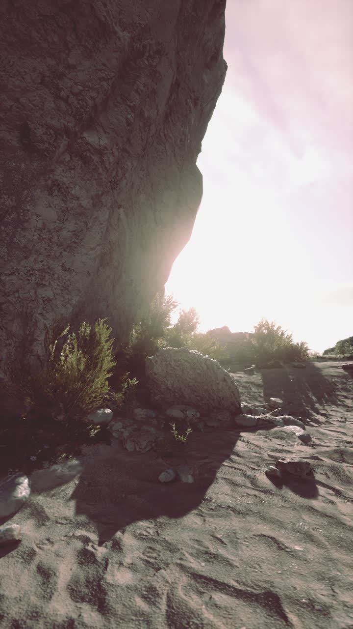 Sun shining through rocks on beach