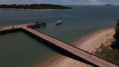 Clip-Aéreo-De-Un-Muelle-En-El-Remoto-Norte-Tropical-De-Australia-Con-Un-Pequeño-Ferry-De-Pasajeros-Que-Sale-Lentamente-Del-Muelle.