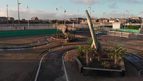 aerial shot of a real-scale brachiosaurus in amusement park, amazing views surrounding the replica of the long-necked dinosaur