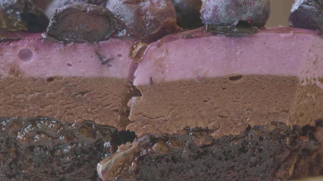 Affettare una ricca torta mousse multistrato al cioccolato e frutti di bosco