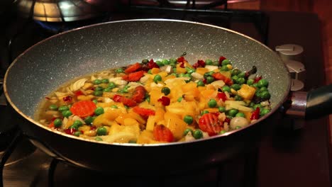 homemade chef hands seasoning fresh vegetables in the pan