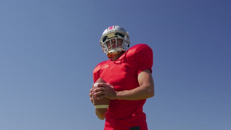 american football player holding a ball