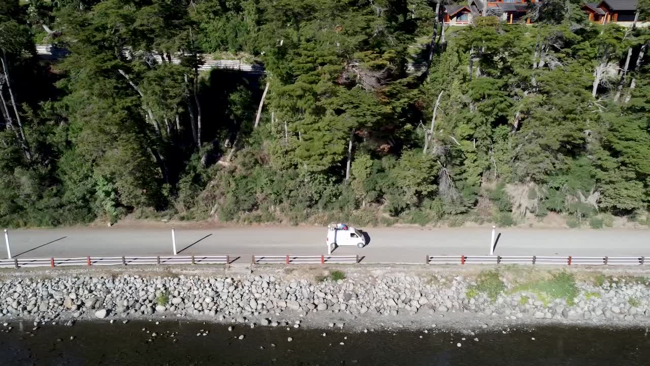 van driving a beautiful road next to the stunning lake shore