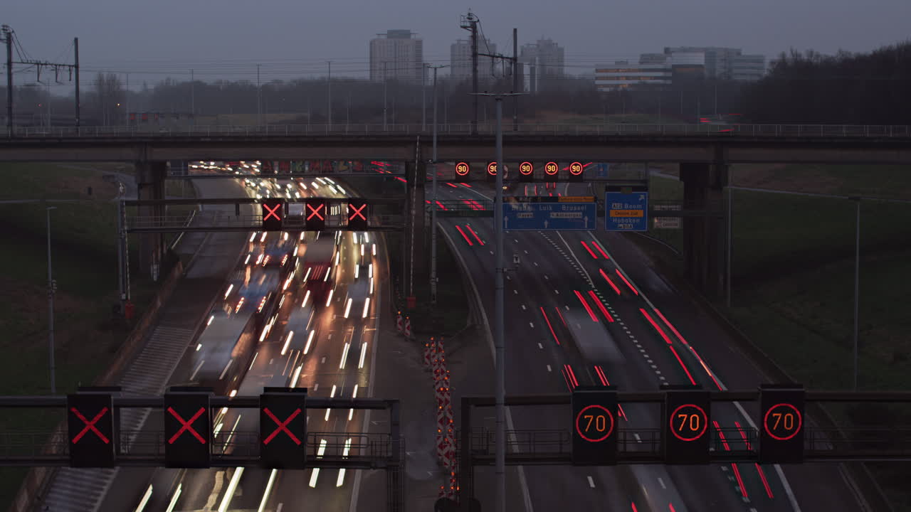 A high-speed timelapse of dense traffic on the R1 Ring Road in Antwerp, Belgium, transitioning from evening to night