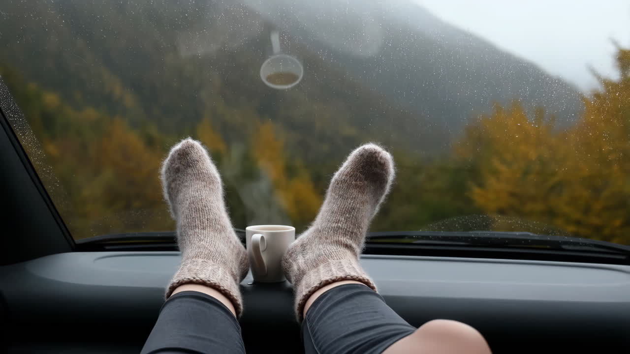 Cozy Feet in Socks on Car Dashboard with Autumn Mountain View