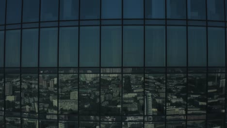 city view reflected in a skyscraper's windows