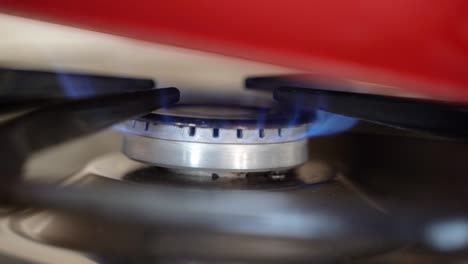 Kitchen-burner-turning-on-with-a-red-pot-on-top