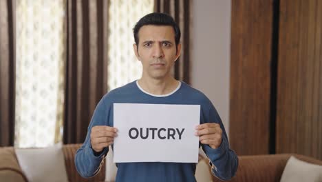 angry indian man holding outcry banner