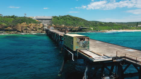 disused old coal loading pier on secluded australia coast, aerial view