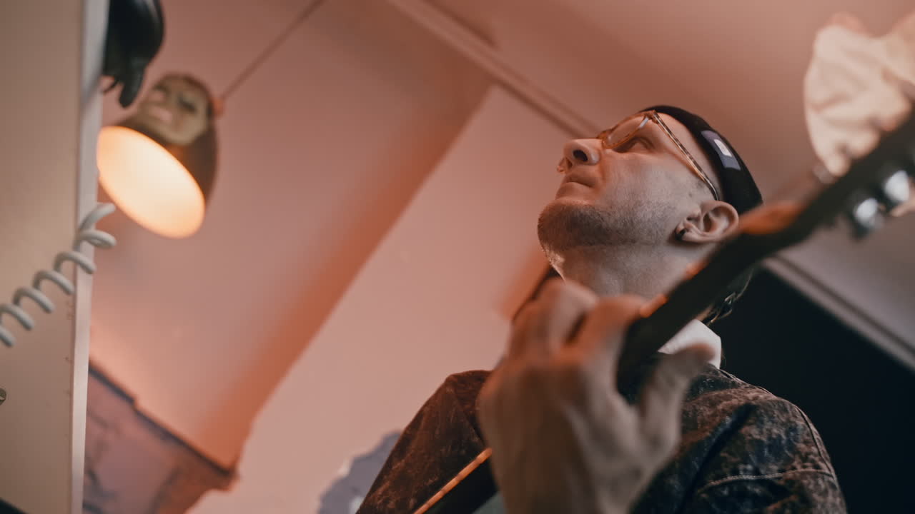 Man playing acoustic guitar in a room
