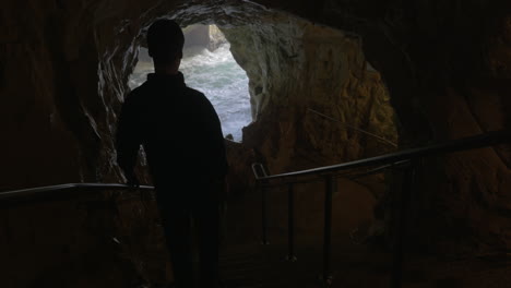 tourist admiring the beauty of sea caves in rosh hanikra