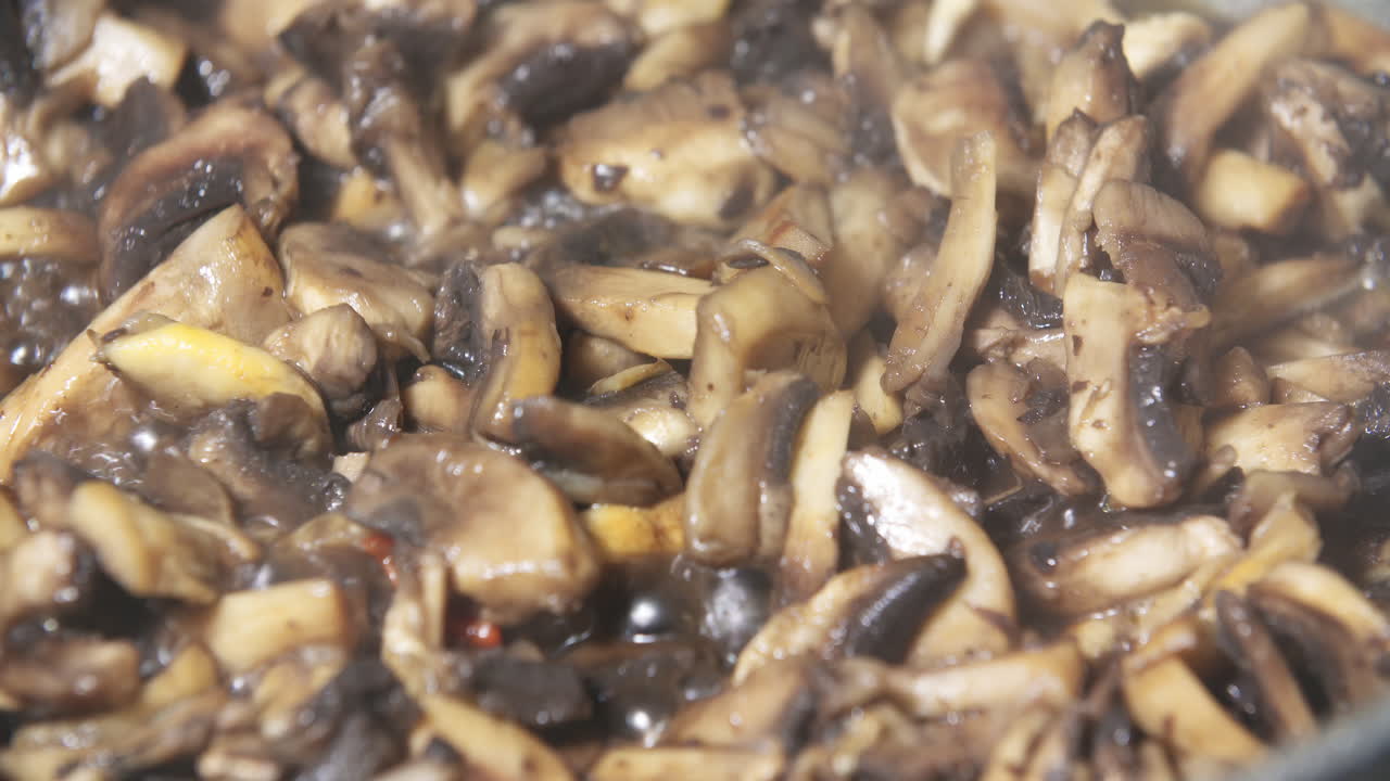 Close Up Of Frying Mushrooms In Butter In A Pan