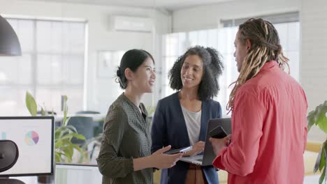 Happy-diverse-casual-business-colleagues-talking-standing-in-office,-slow-motion