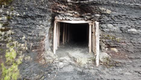 Entering-an-abandonned-mine-with-broken-supports-and-water-leaking-through