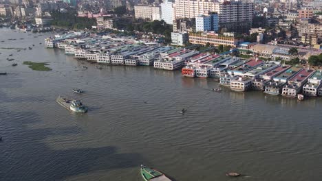 zoom in shot of charters, cargo ships, vessels and oil tankers in dhaka port, bangladesh