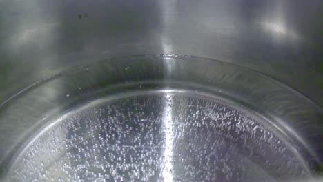 closeup of boiling water in silver pot