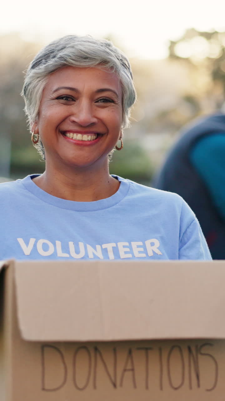 Happy Senior Woman Volunteer Holding a Donations Box