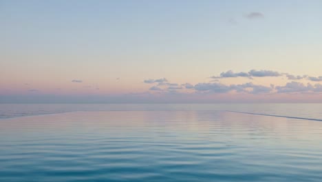 Captivating Serenity: A Tranquil Evening Over Still Waters Reflecting Soft Pastels as the Day Transitions to Night with Gentle Waves Lapping the Peaceful Shoreline