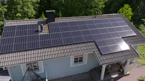 Drone circling a reflecting surface of a solar cell array on a modern house roof